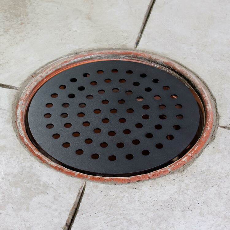 A black steel garage floor drain cover