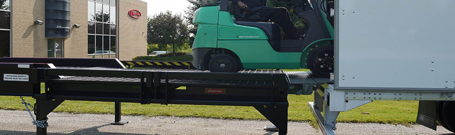 A forklift using a Copperloy loading dock ramp.