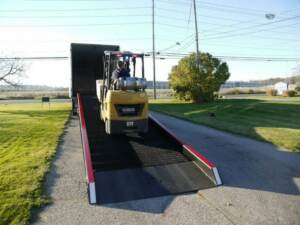 Forklift traveling up a Copperloy yard ramp rental